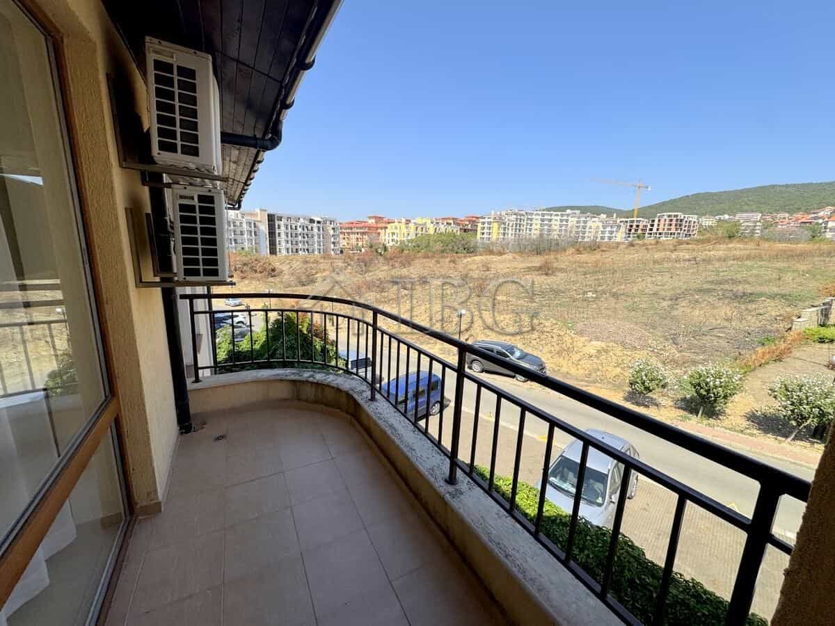 Balcony overlooking scenic mountains and residential area in Sveti Vlas, Bulgaria.