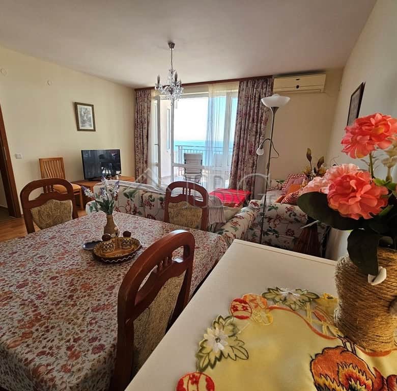 Sea view one-bedroom apartment with modern furnishings and balcony overlooking the sea.