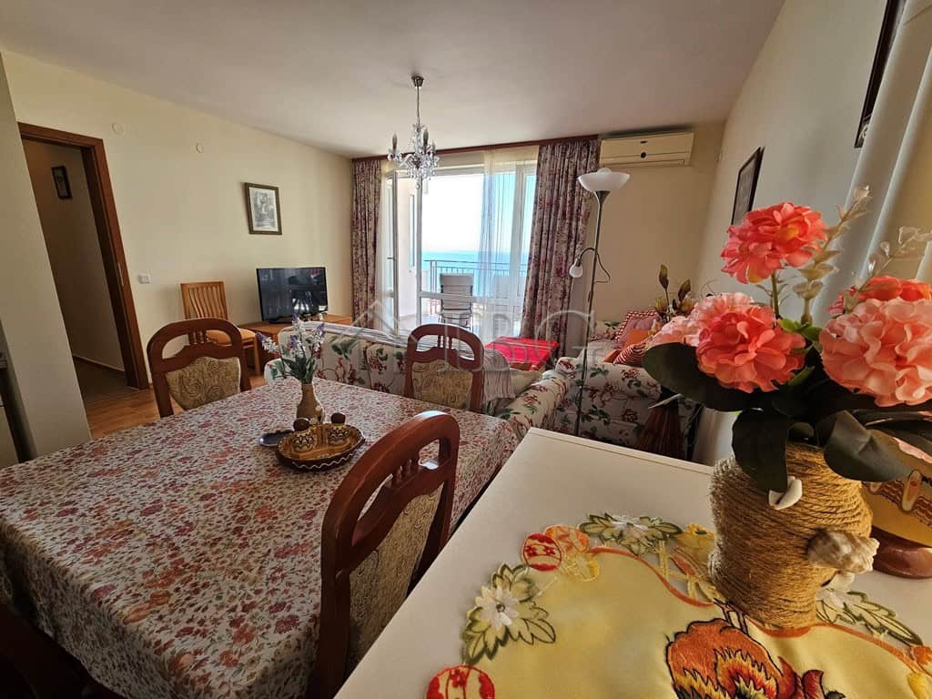 Sea view one-bedroom apartment with modern furnishings and balcony overlooking the sea.