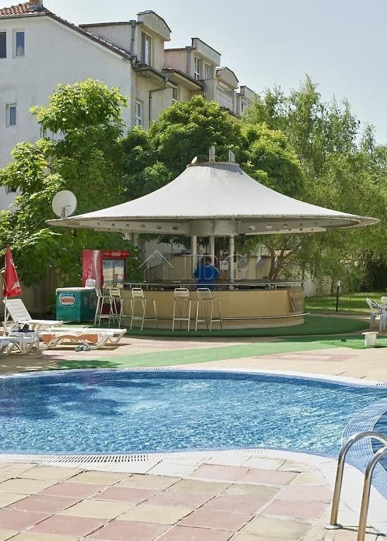 Sunny Beach apartment with pool and garden views.