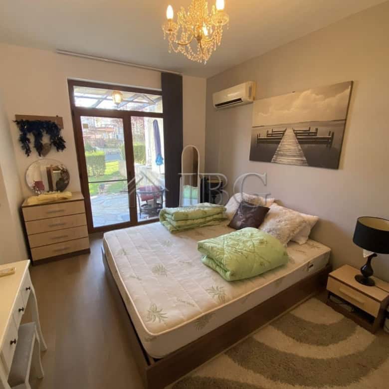 Cozy bedroom with a large bed, private yard access, and modern decor in Vineyards Resort, Aheloy.