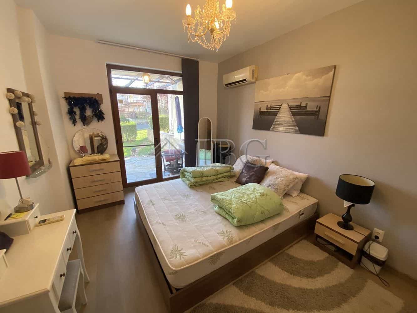 Cozy bedroom with a large bed, private yard access, and modern decor in Vineyards Resort, Aheloy.