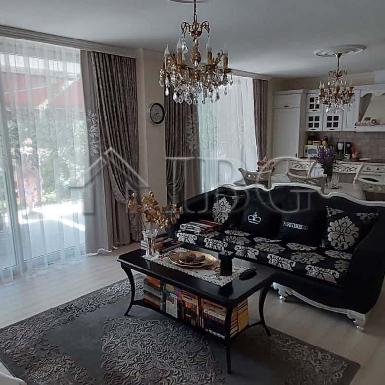 Elegant two-storey townhouse living room with modern furnishings and large windows in Sarafovo.