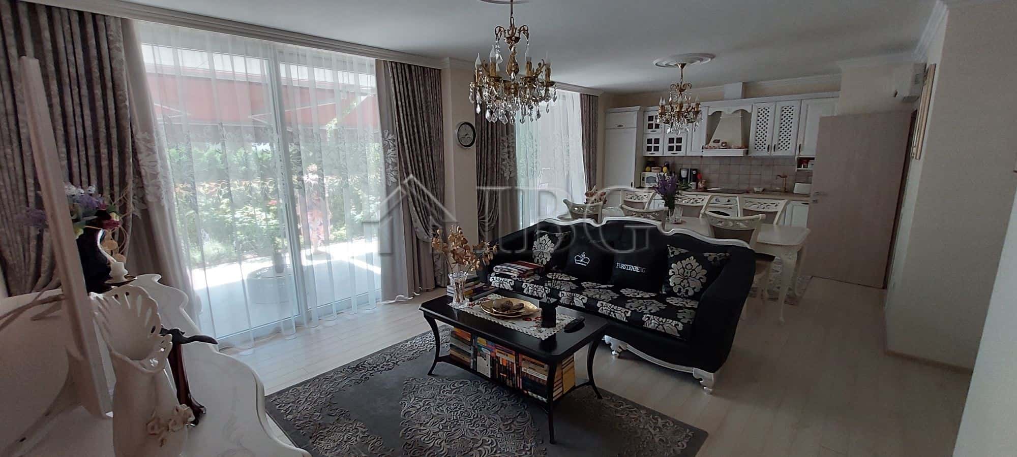 Elegant two-storey townhouse living room with modern furnishings and large windows in Sarafovo.