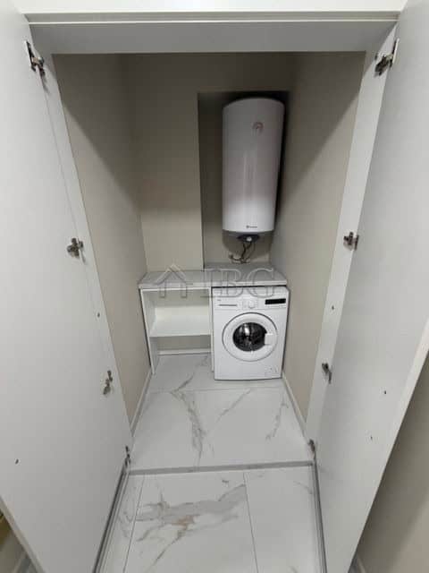 Laundry closet with washing machine and water heater in a luxury apartment in Sarafovo.