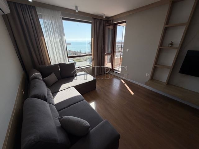 Bright living room with panoramic sea views from large windows.