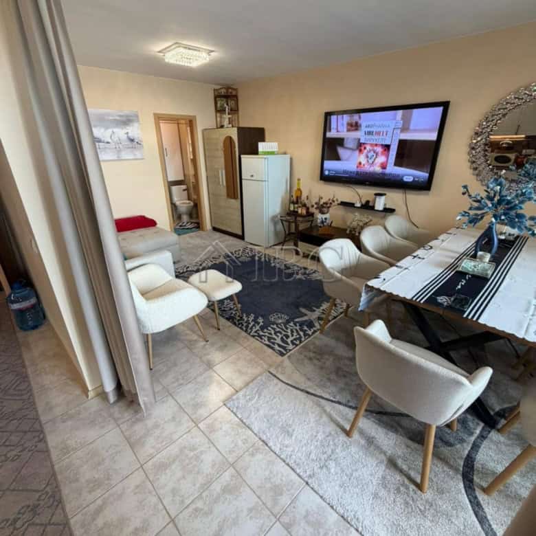 Cozy 1-bedroom apartment with living area, TV, and dining space in Sunny Beach.
