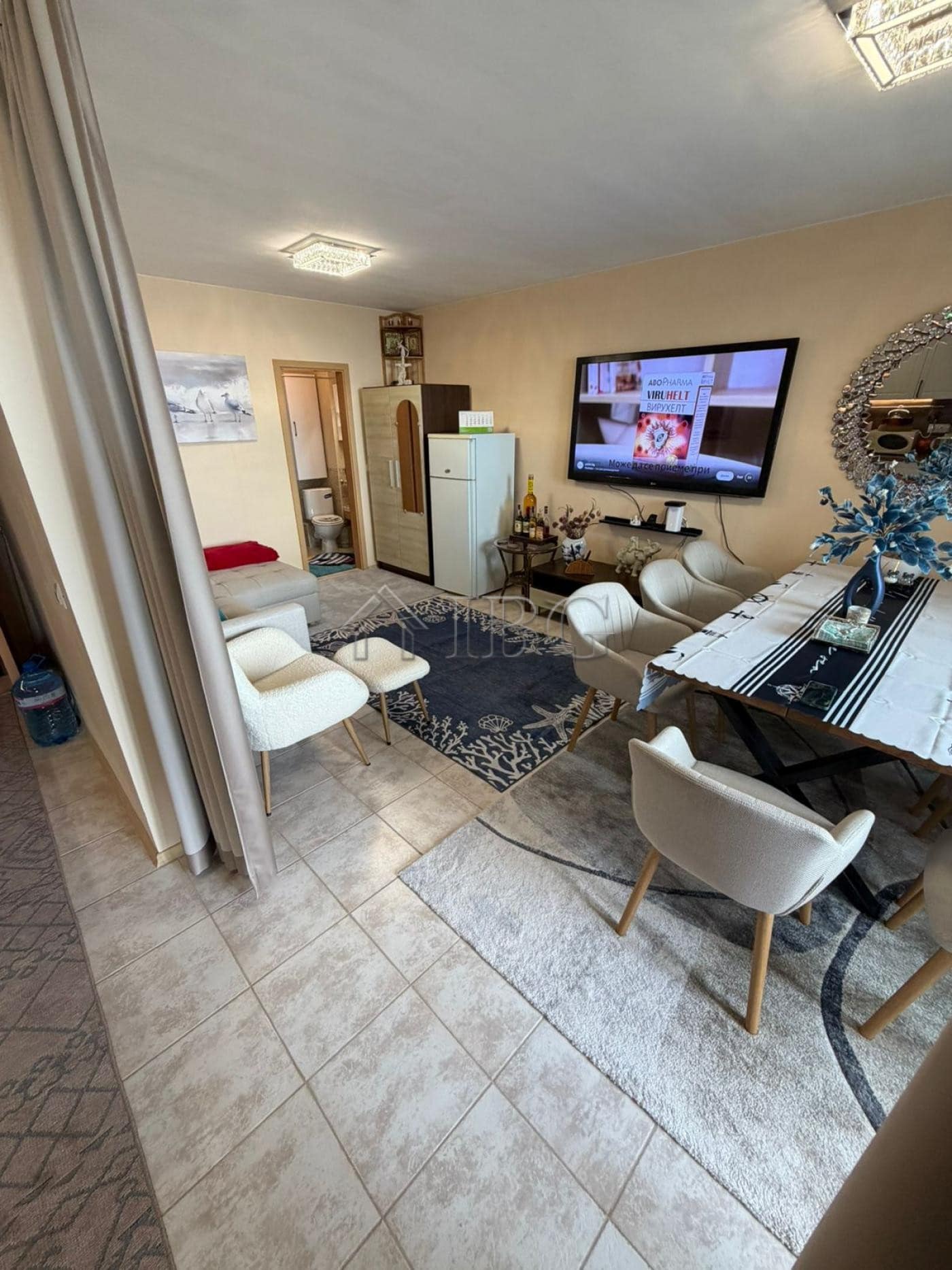 Cozy 1-bedroom apartment with living area, TV, and dining space in Sunny Beach.