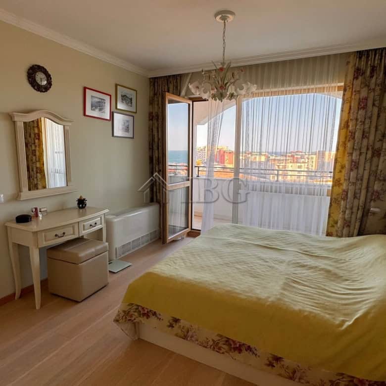 Spacious bedroom with large window offering stunning sea and mountain vistas in Sveti Vlas.