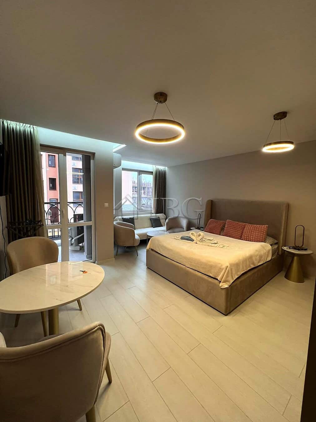 Furnished studio with balcony, modern decor, and city views in Sunny Beach.