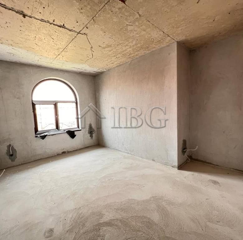 Unfinished apartment interior with a large arched window and panoramic sea views in Sveti Vlas.