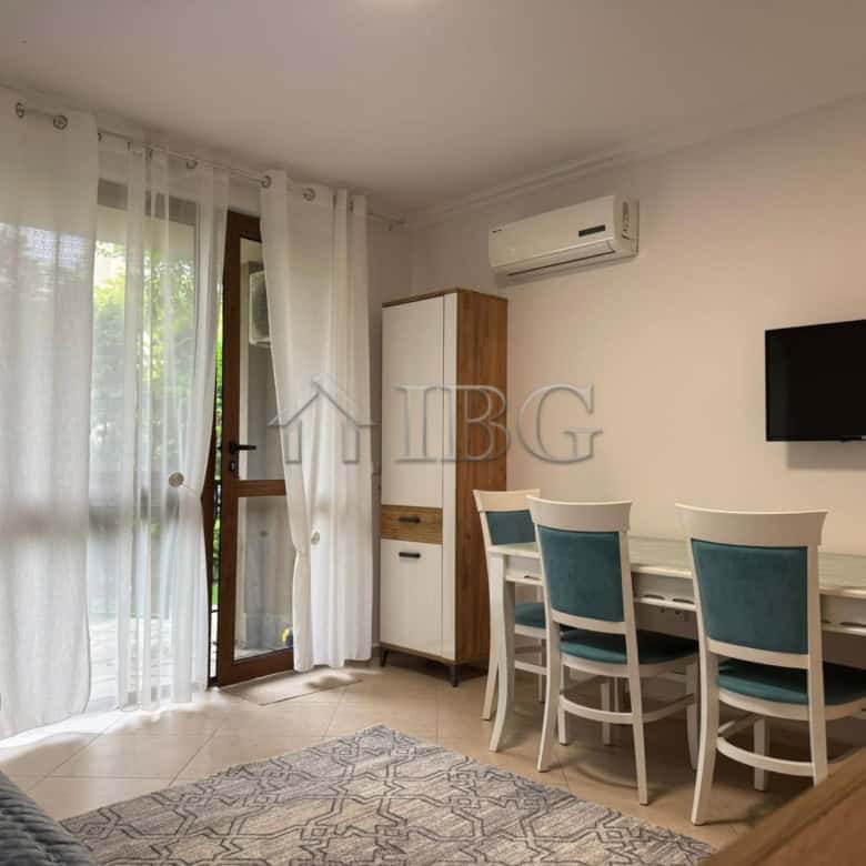 Bright studio apartment with balcony overlooking lush green yard in Cascadas Complex, Sunny Beach.