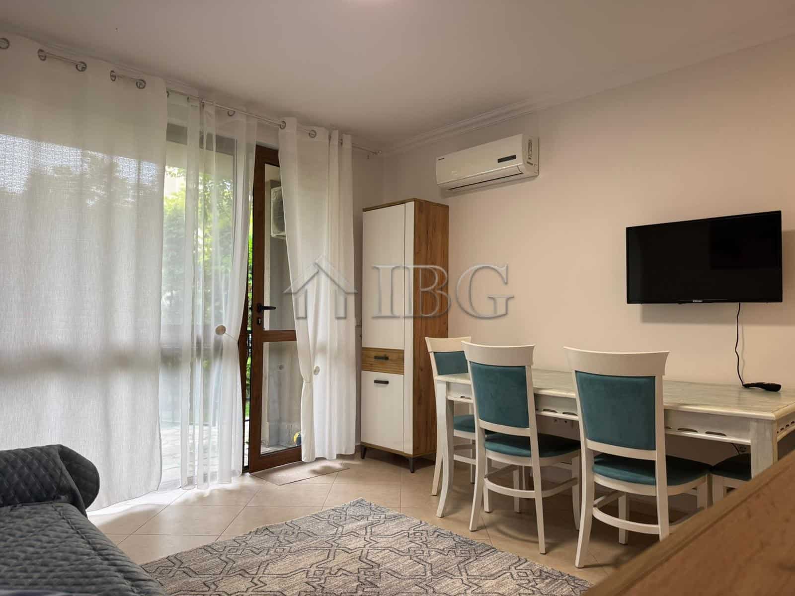 Bright studio apartment with balcony overlooking lush green yard in Cascadas Complex, Sunny Beach.