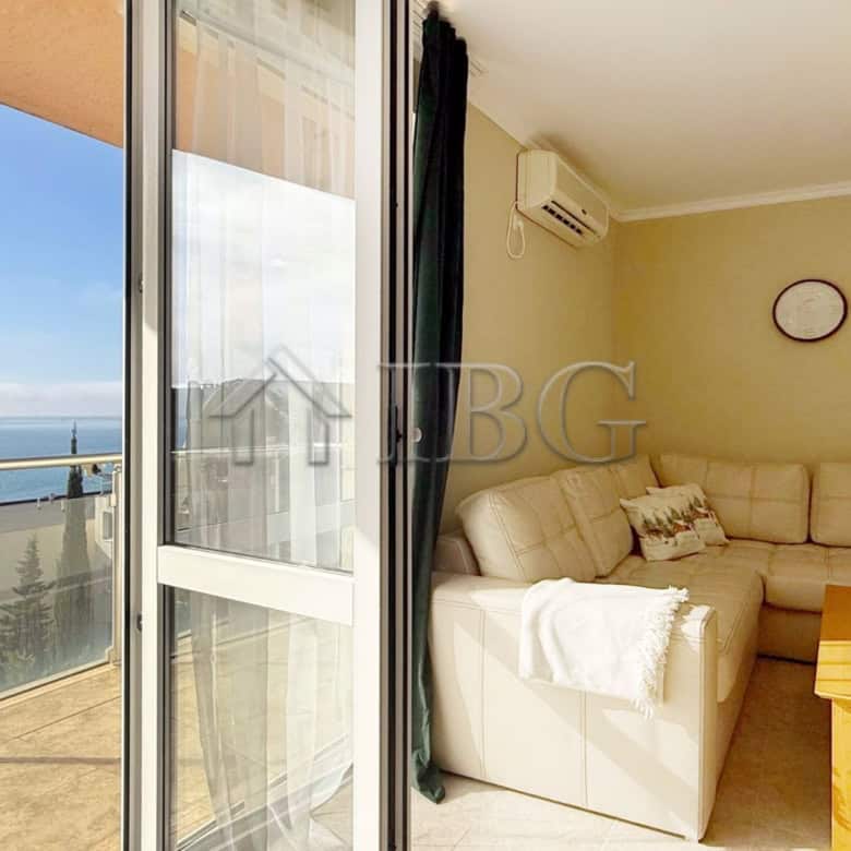 Bright living room with sea view balcony in Sveti Vlas apartment.