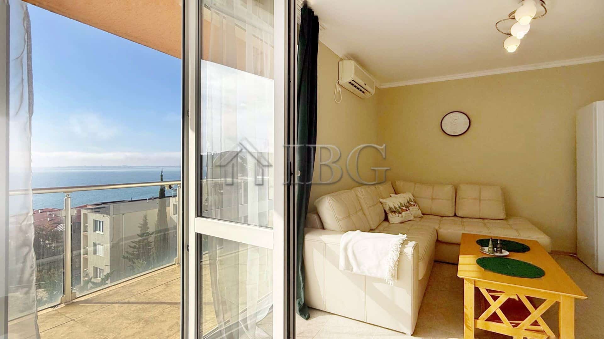 Bright living room with sea view balcony in Sveti Vlas apartment.