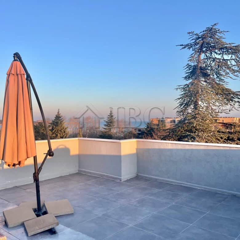 Modern terrace with sea view and outdoor umbrella in Ravda apartment.
