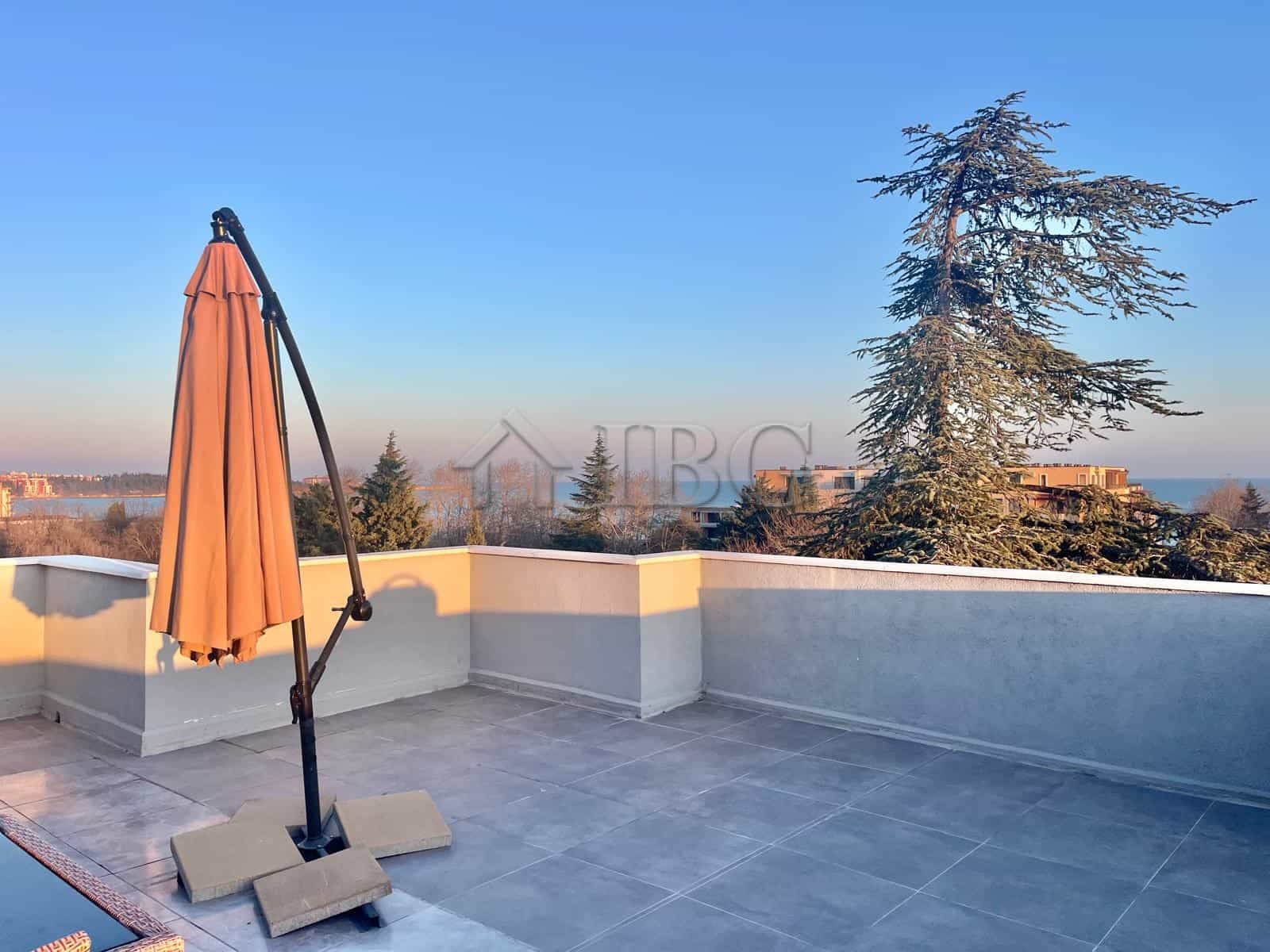 Modern terrace with sea view and outdoor umbrella in Ravda apartment.