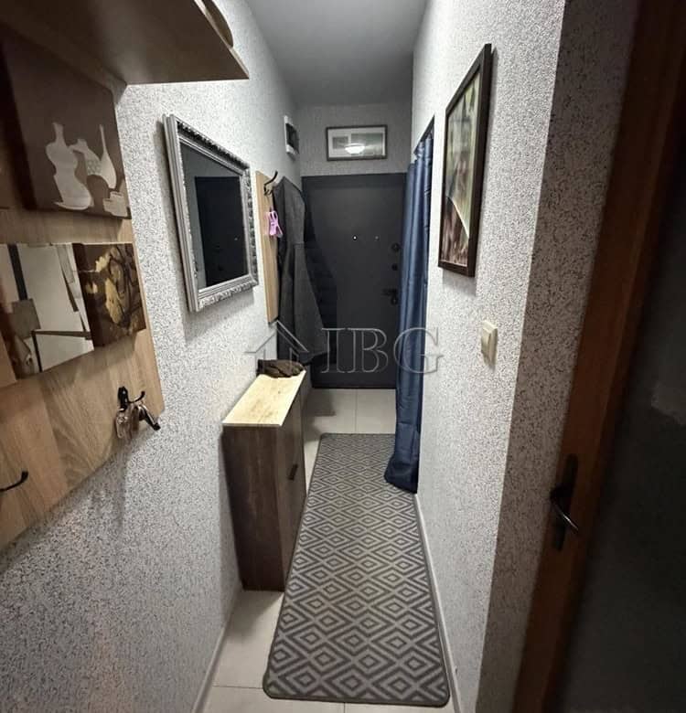 Bright hallway of a new one-bedroom apartment with stylish decor and a view of the large terrace in.