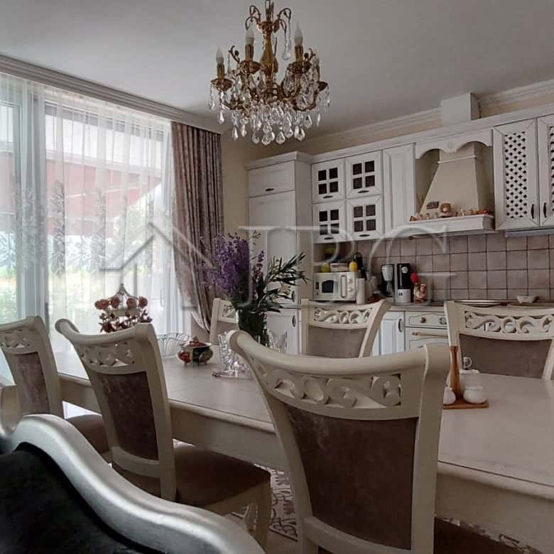 Elegant two-storey townhouse living area with classic decor and spacious dining space.