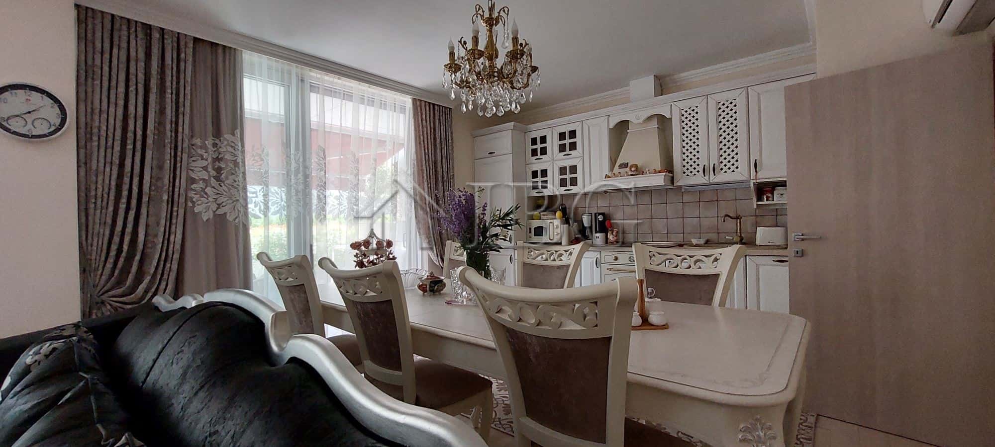 Elegant two-storey townhouse living area with classic decor and spacious dining space.