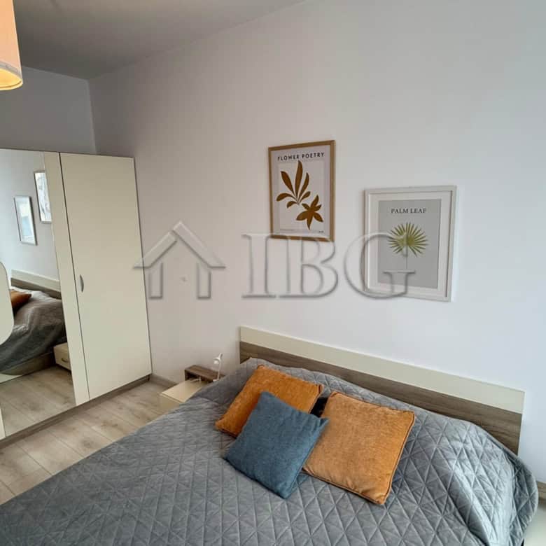 Bright bedroom with stylish decor and comfortable bedding in Pomorie Beach Resort.