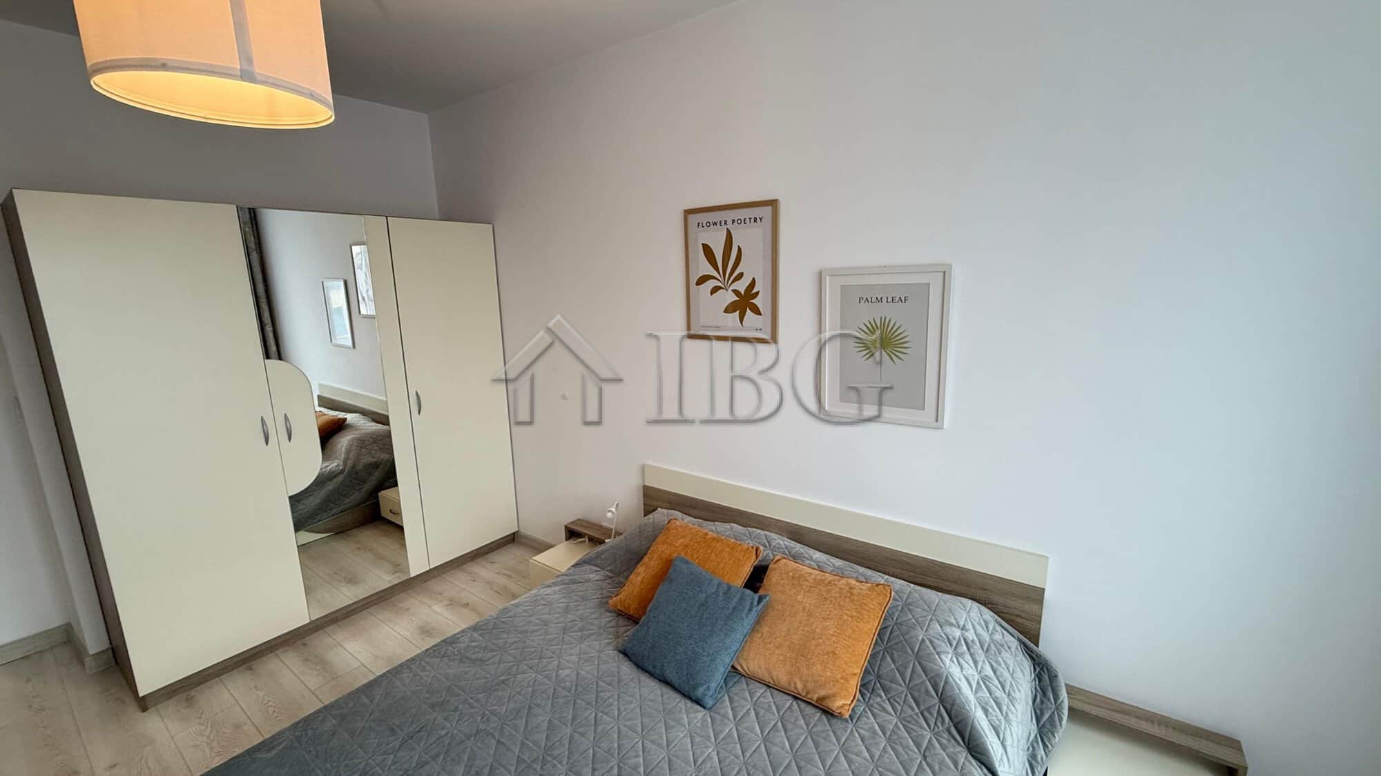 Bright bedroom with stylish decor and comfortable bedding in Pomorie Beach Resort.