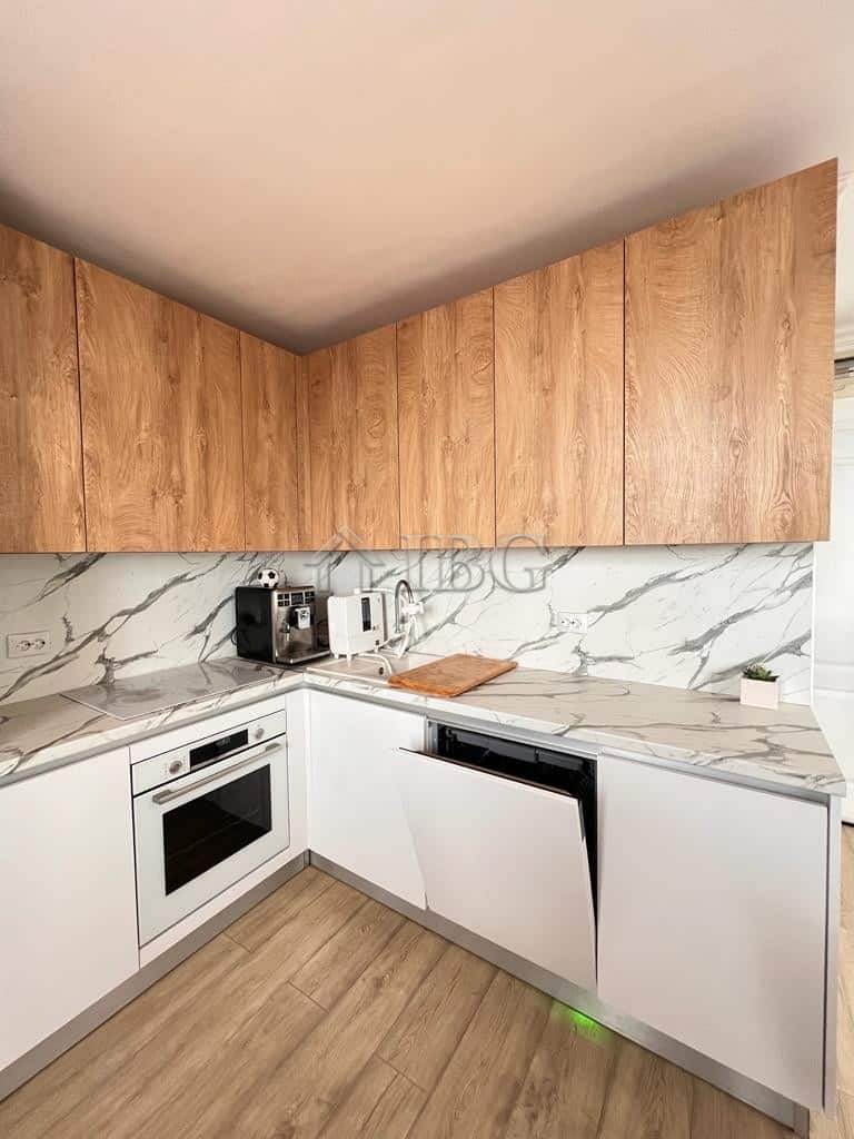 Modern kitchen with wooden cabinets and marble backsplash in Sveti Vlas.