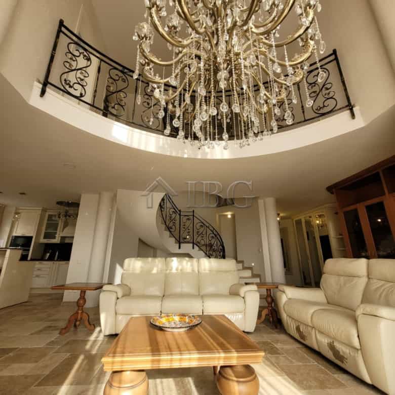 Elegant interior of a three-level maisonette featuring a grand chandelier and spacious living area.