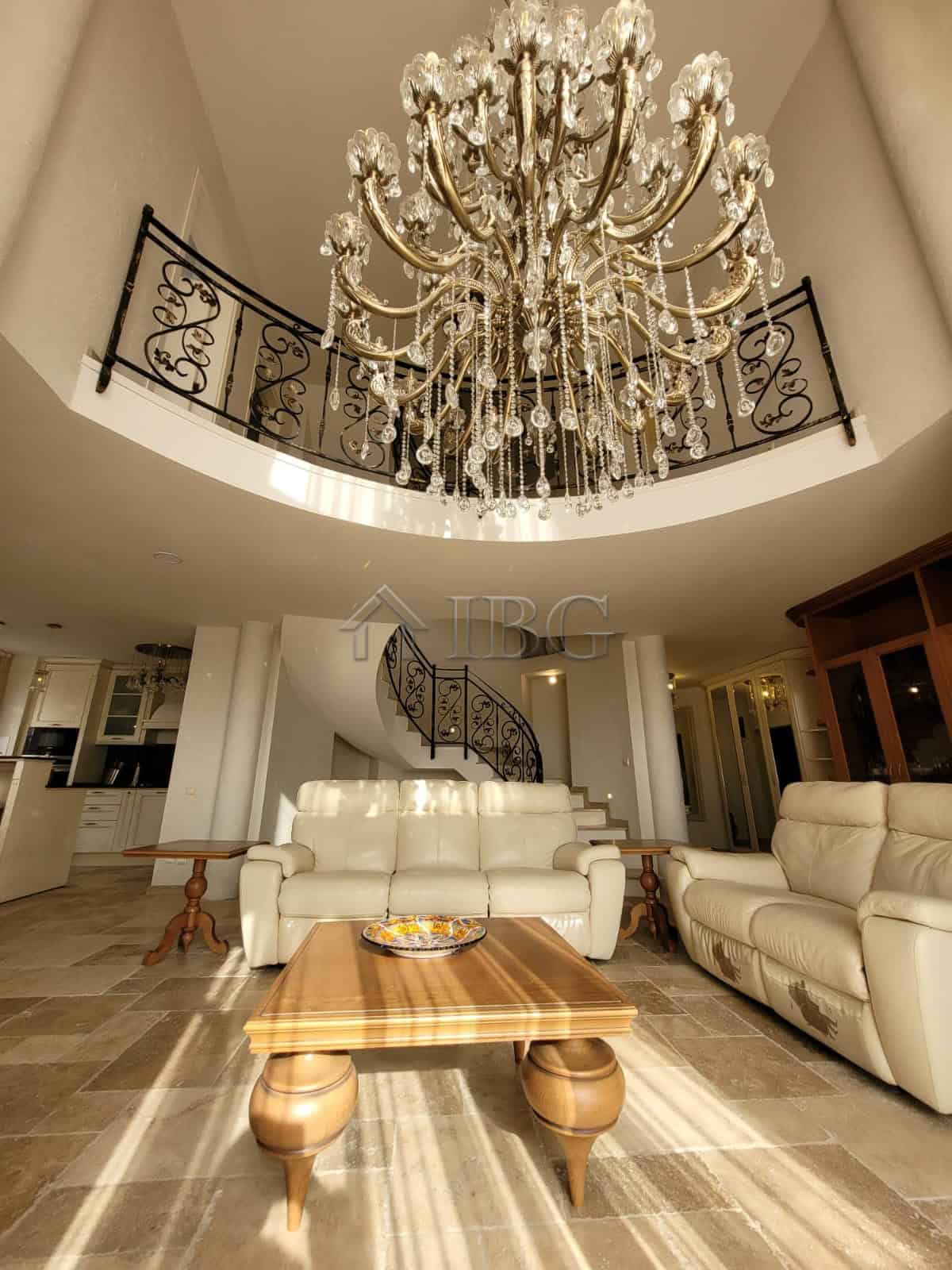 Elegant interior of a three-level maisonette featuring a grand chandelier and spacious living area.