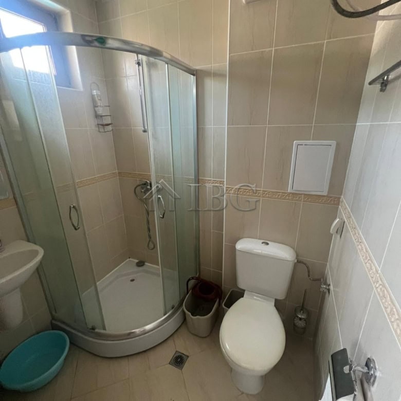 Bathroom with shower, toilet, and window in Sveti Vlas.