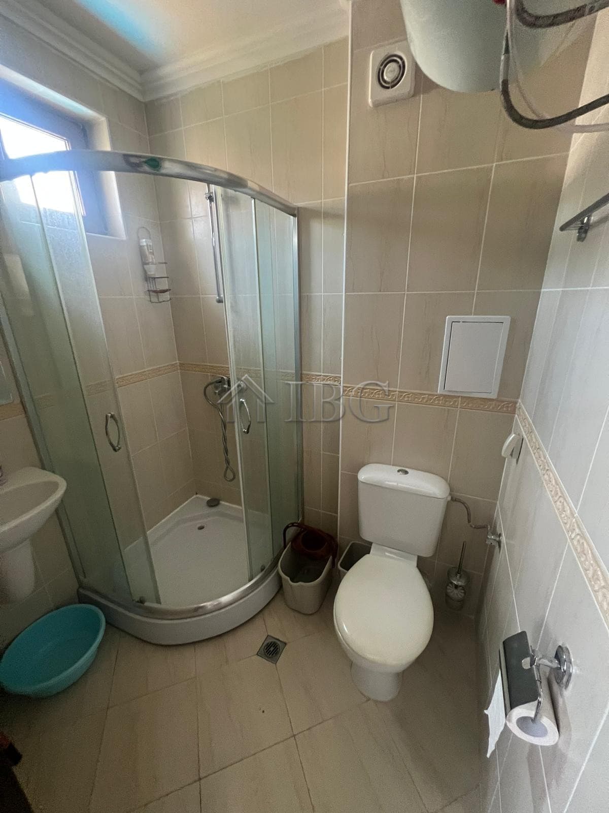 Bathroom with shower, toilet, and window in Sveti Vlas.