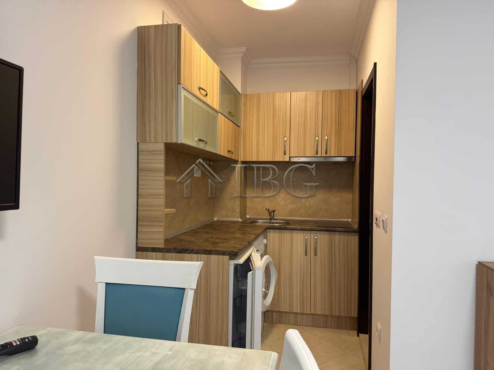 Bright studio apartment with balcony overlooking lush green yard in Cascadas Complex, Sunny Beach.