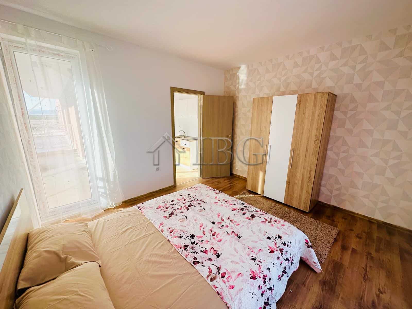 Comfortable bedroom with a large bed and floral bedding in a sunny apartment.