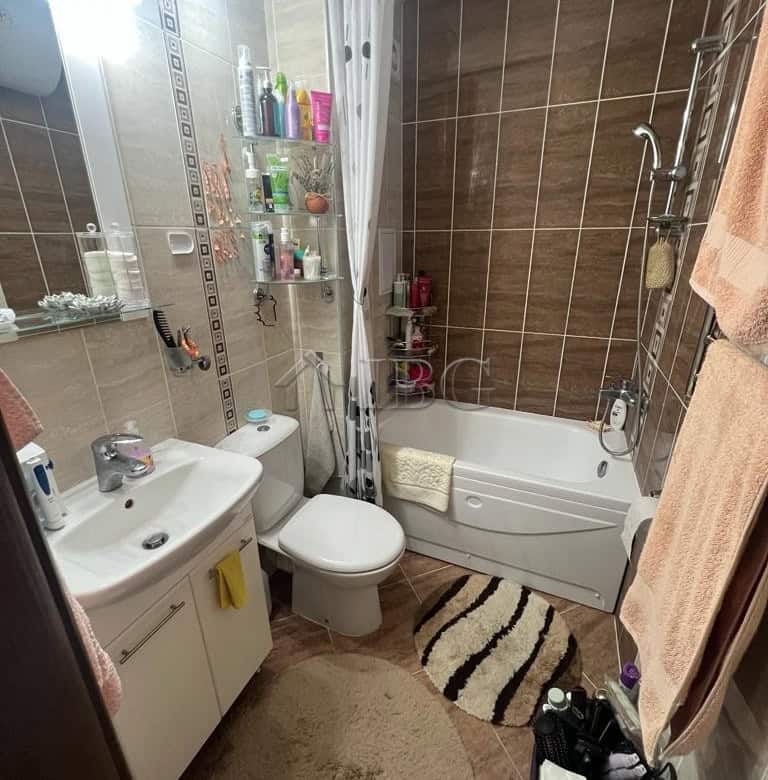 Bright bathroom with modern fixtures, ample storage, and sea view from the window. Perfect for relax.
