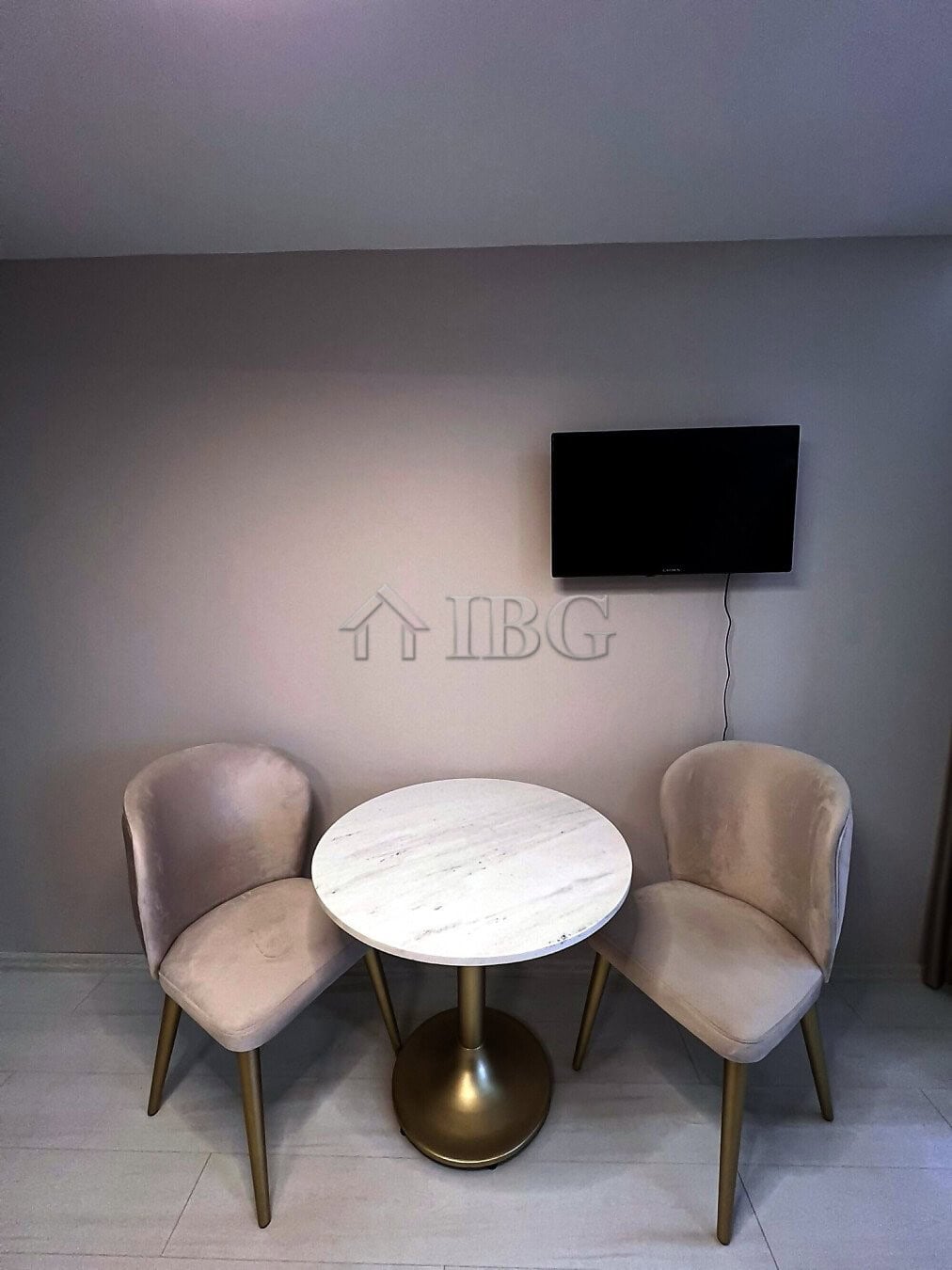 Furnished studio with balcony, modern decor, and a flat-screen TV in a new complex at Sunny Beach.