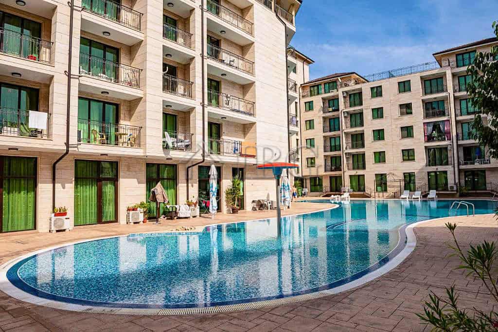 Bright and spacious living space with access to a shared swimming pool.