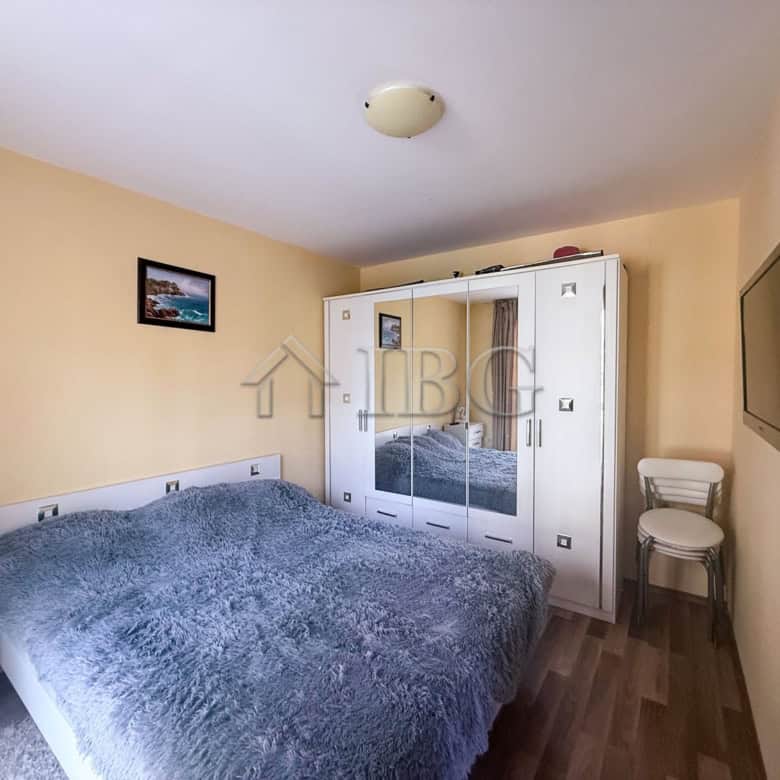 Apartment interior with a double bed, wardrobe, and TV in Sunny Beach, Bulgaria.