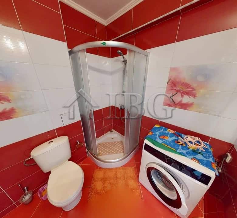 Bright bathroom with shower cabin and washing machine in Amber Beach Complex, Sunny Beach.