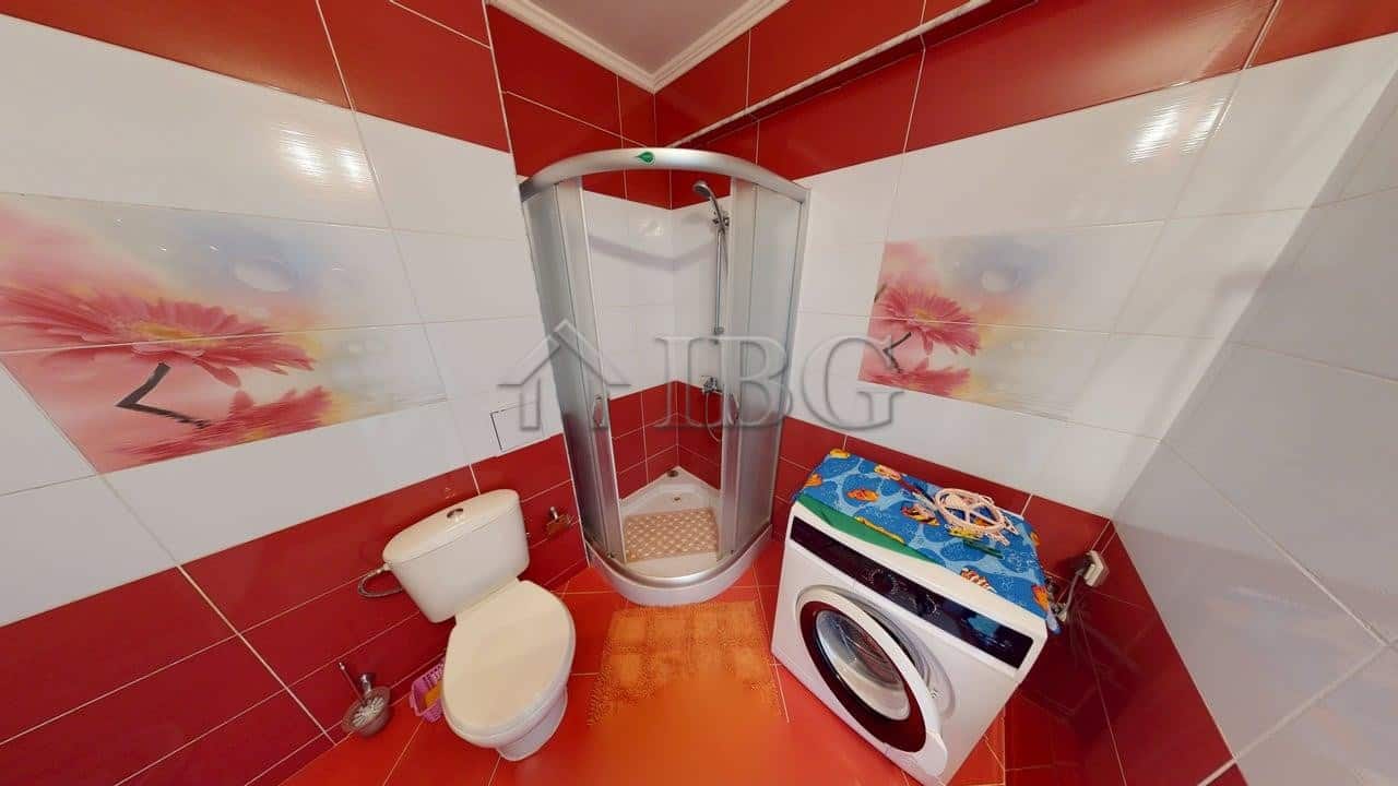 Bright bathroom with shower cabin and washing machine in Amber Beach Complex, Sunny Beach.