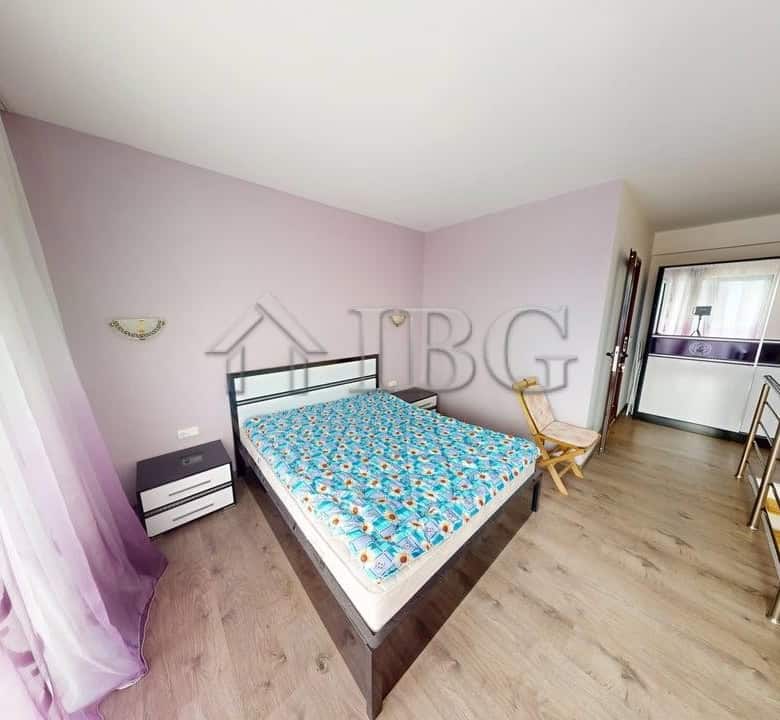 Bright bedroom with pool view, double bed, and modern decor at Amber Beach Complex, Sunny Beach.