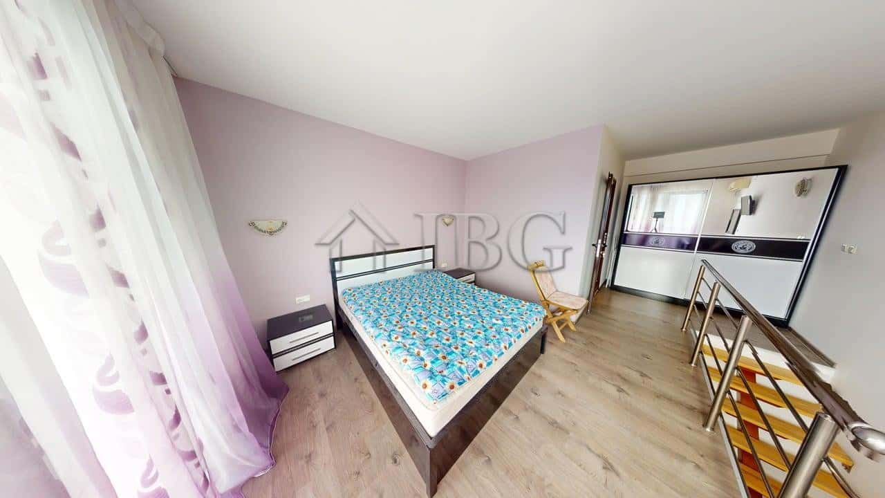 Bright bedroom with pool view, double bed, and modern decor at Amber Beach Complex, Sunny Beach.