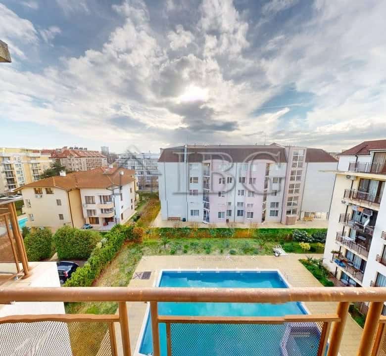 View of pool and surrounding buildings from a one-bedroom apartment balcony in Sunny Beach.