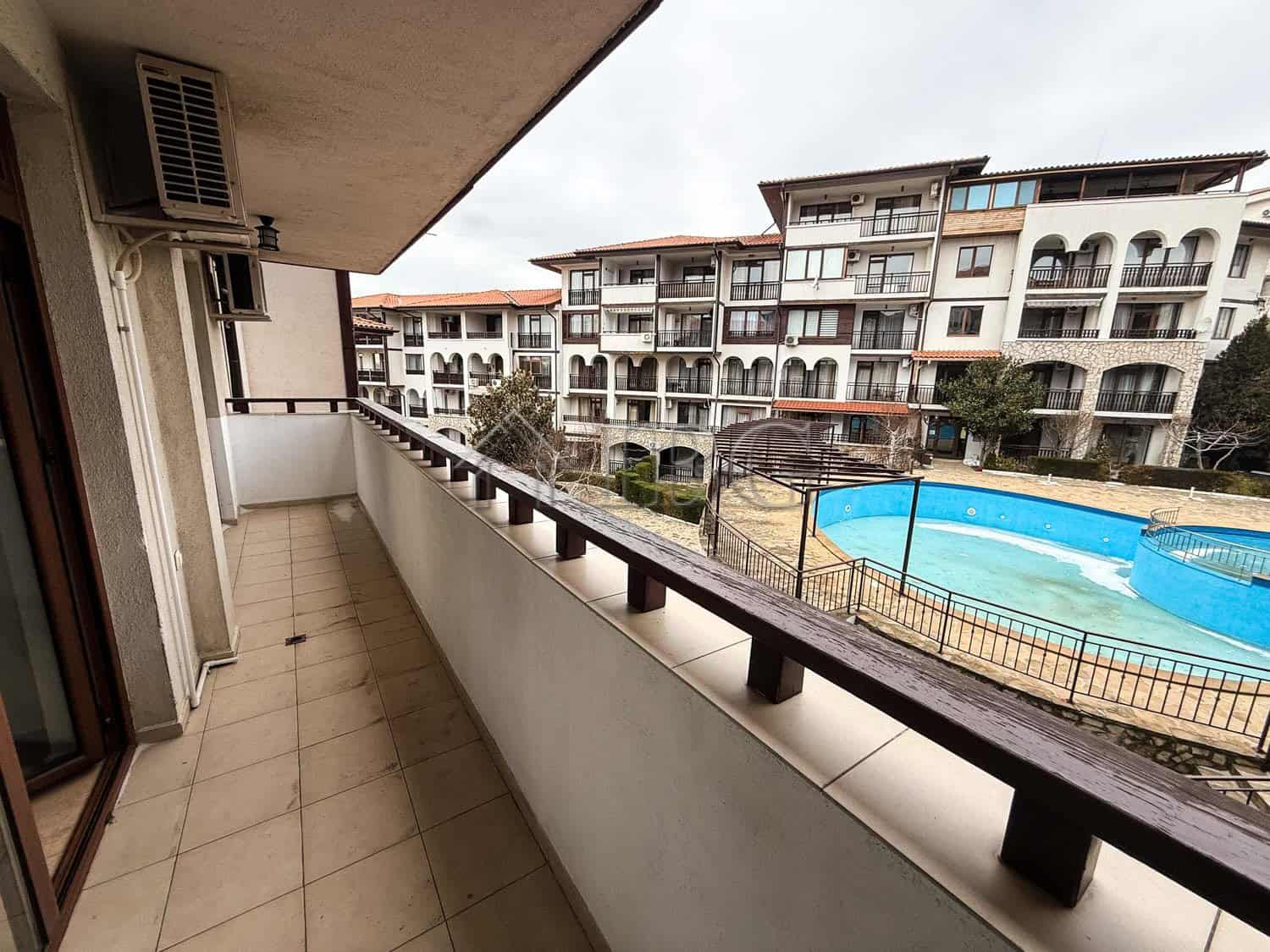 Balcony view of the apartment overlooking the pool and surrounding buildings in Sveti Vlas.