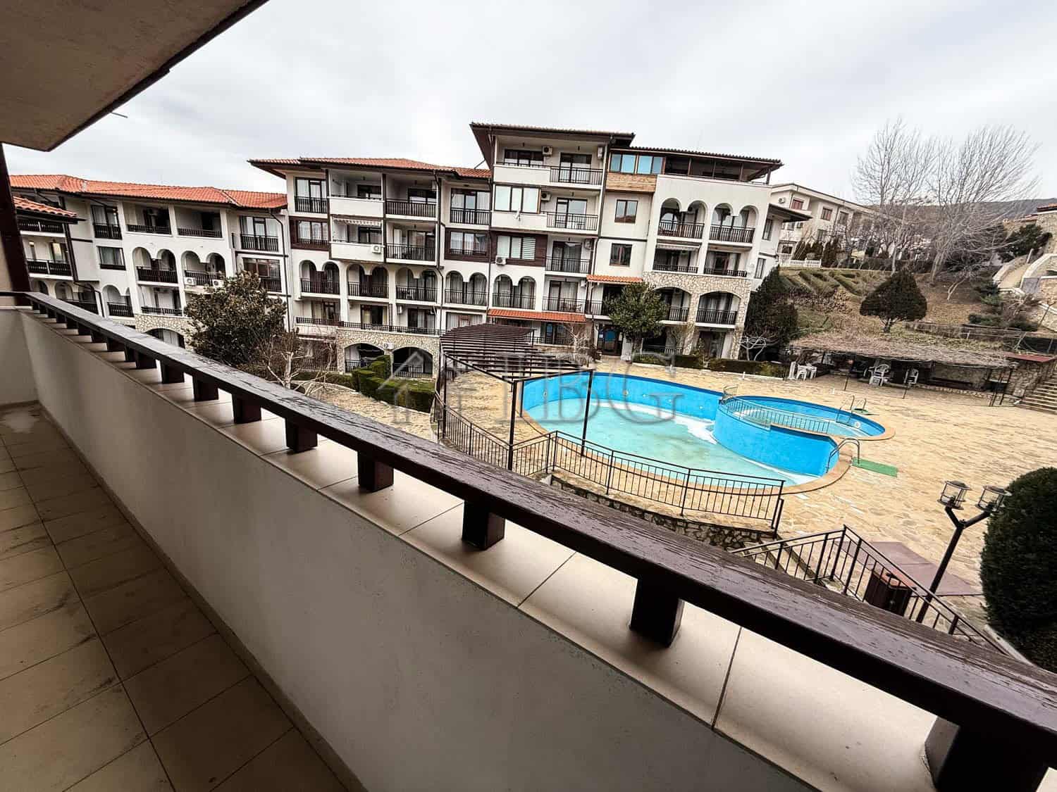 Bright balcony view of apartment complex and swimming pool in Sveti Vlas.