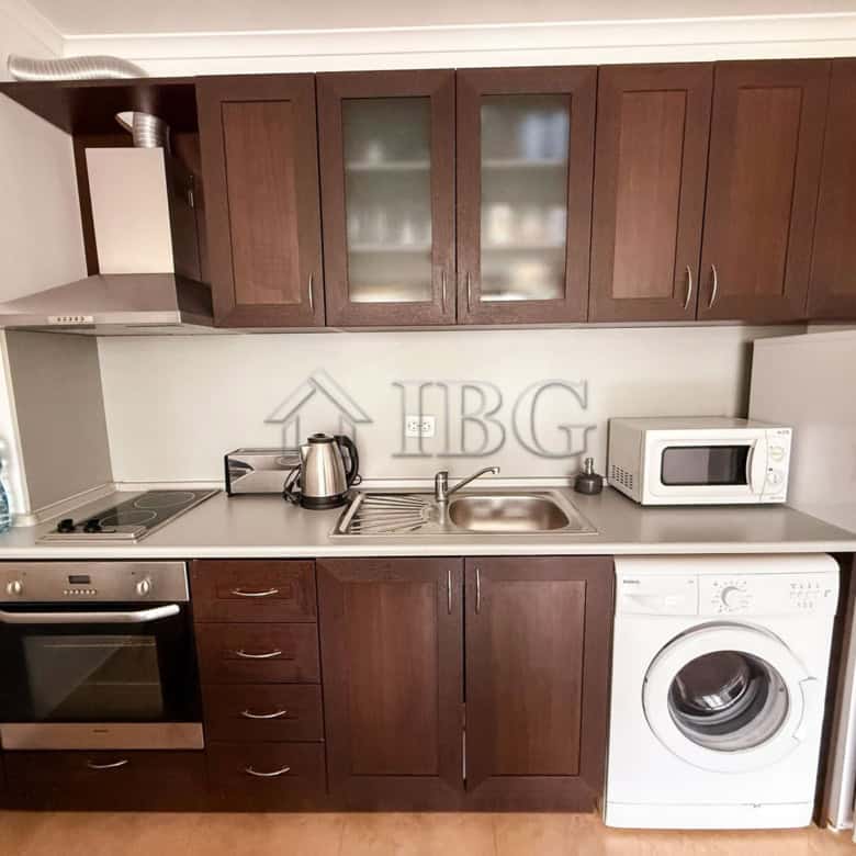 Bright kitchen with modern appliances and wooden cabinets in Arena 1, Sveti Vlas.