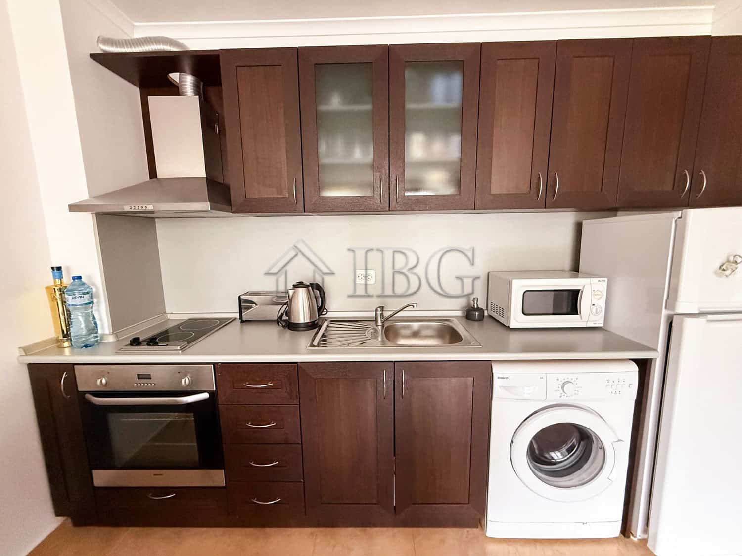 Bright kitchen with modern appliances and wooden cabinets in Arena 1, Sveti Vlas.
