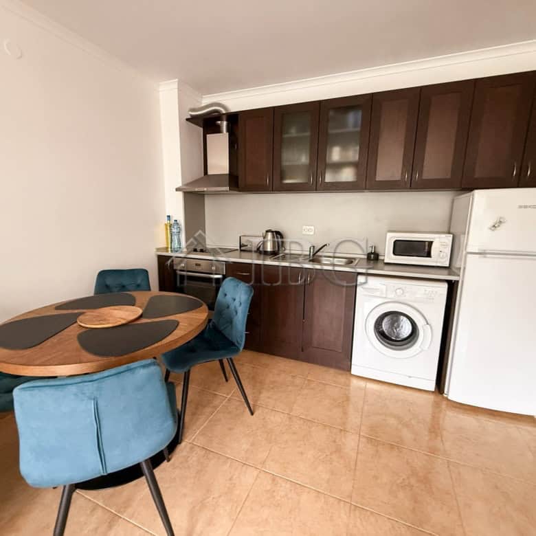 Bright furnished apartment with modern kitchen and seating area, ideal for seaside living in Sveti V.