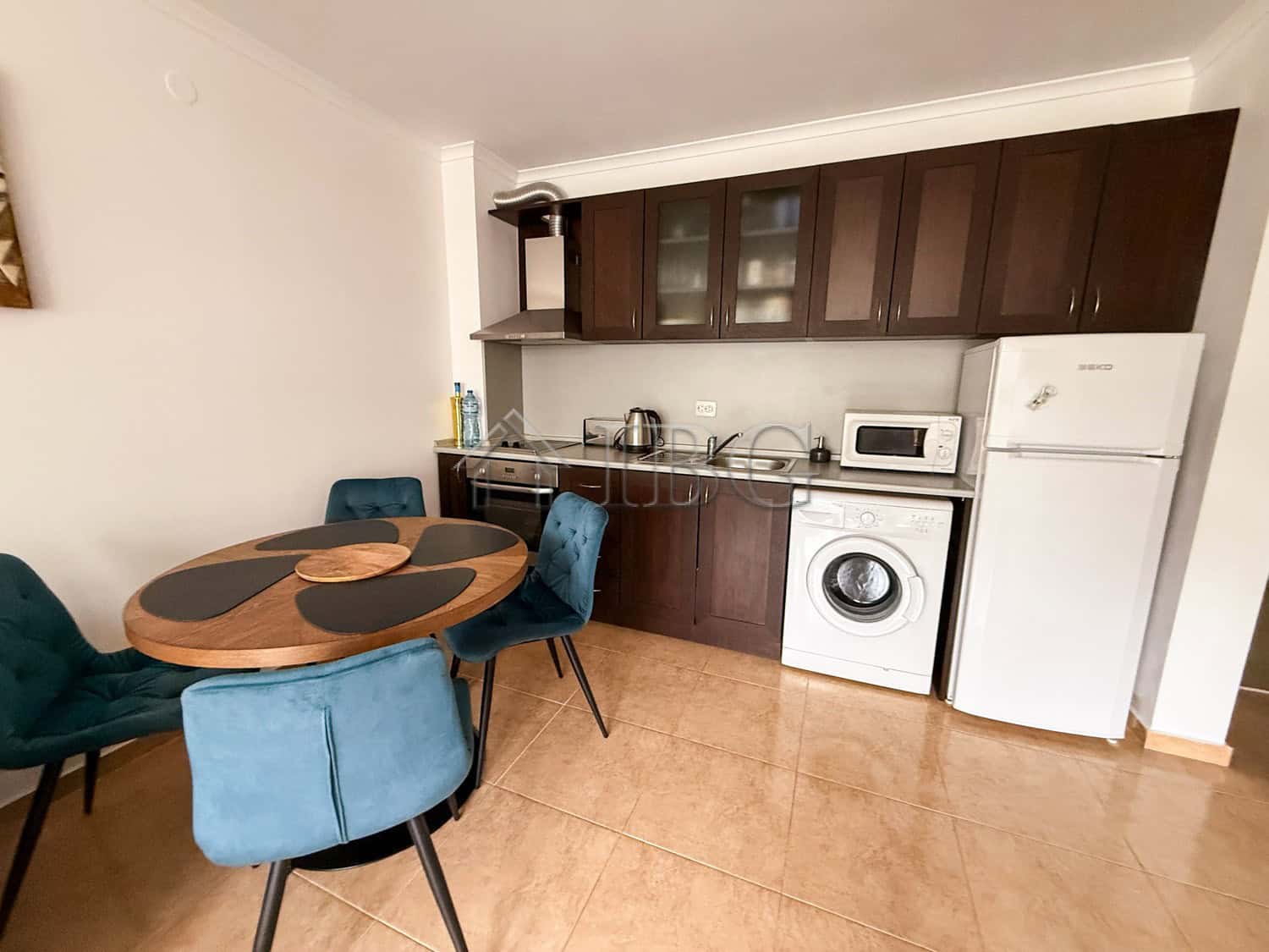 Bright furnished apartment with modern kitchen and seating area, ideal for seaside living in Sveti V.