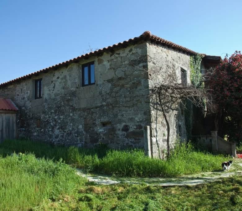 Chantada stone house for sale in Lugo, Spain, featuring traditional architecture and spacious outdoo.