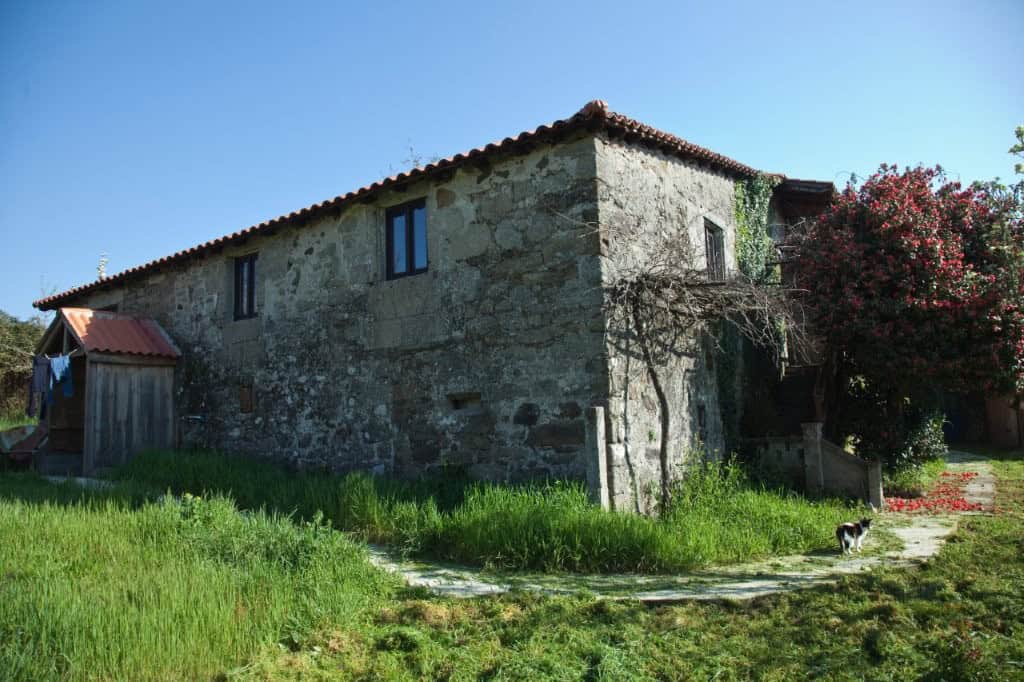 Chantada stone house for sale in Lugo, Spain, featuring traditional architecture and spacious outdoo.
